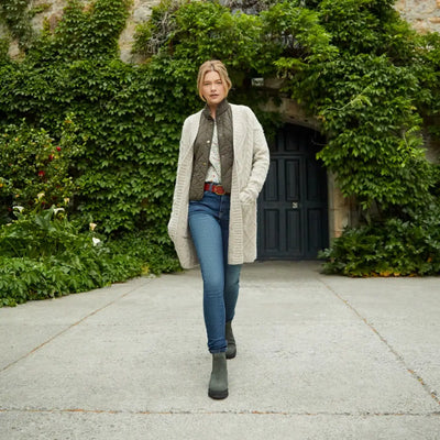 Woman in a long white cardigan and jeans rocking Ariat Wexford Lug Waterproof Chelsea Boots