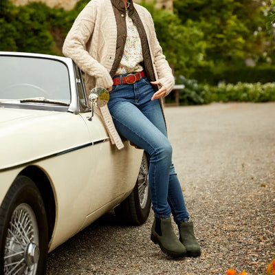 Classic white vintage car with person leaning on fender, perfect for Ariat Wexford Lug waterproof boots