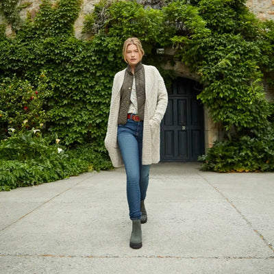 Woman in long white cardigan, jeans, and boots featuring Ariat Wexford Lug Waterproof