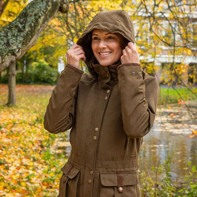 Woman wearing a Baleno Ladywood Jacket in a stylish hooded brown coat