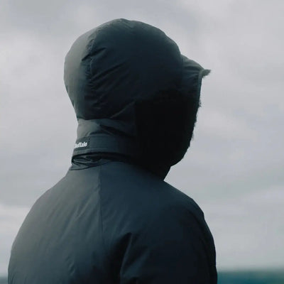 Person in a dark hooded jacket wearing Buffalo DP Hood with aquatherm pile lining