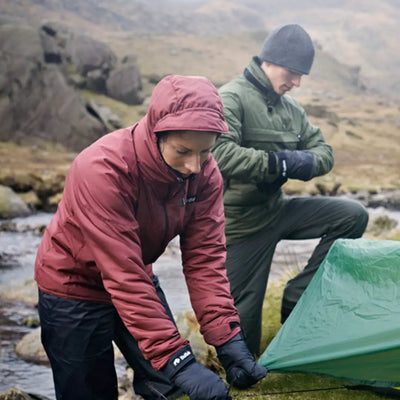 Two adventurers setting up a tent in the Buffalo Mountain Shirt on rugged terrain