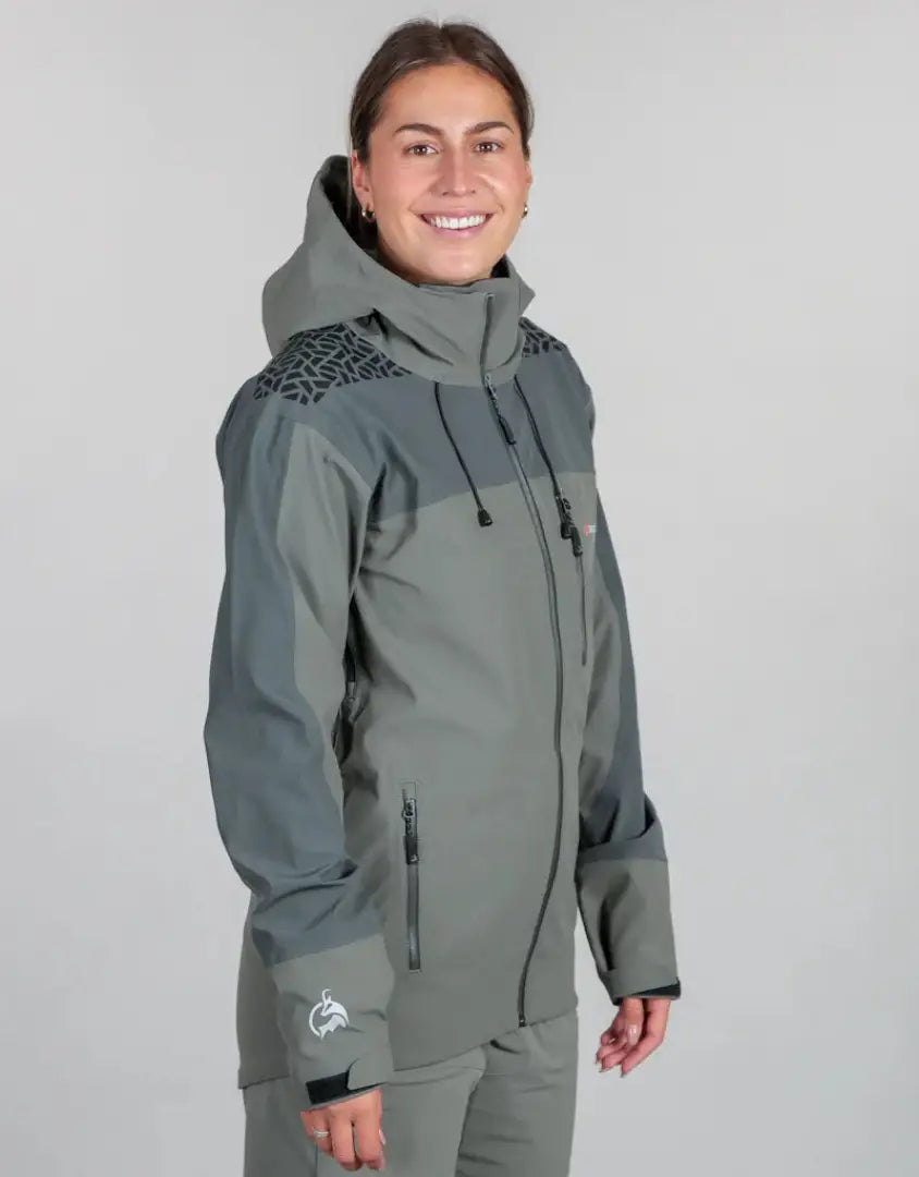 Woman in a gray Bushbuck Alpine Waterproof Jacket showing off the alpine waterproof jacket style