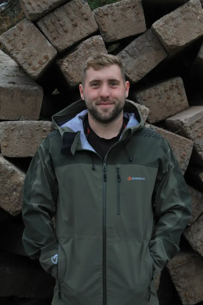 Man in a green Bushbuck Alpine Waterproof Jacket for wet weather country clothing