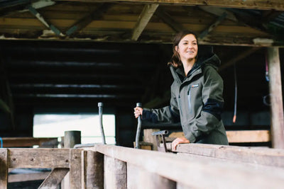 Woman in olive green Bushbuck Defender Waterproof Jacket, perfect country clothing for hunting
