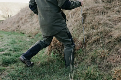 Hunter in outdoor gear wearing Bushbuck Defender Waterproof Trousers for hunting adventures