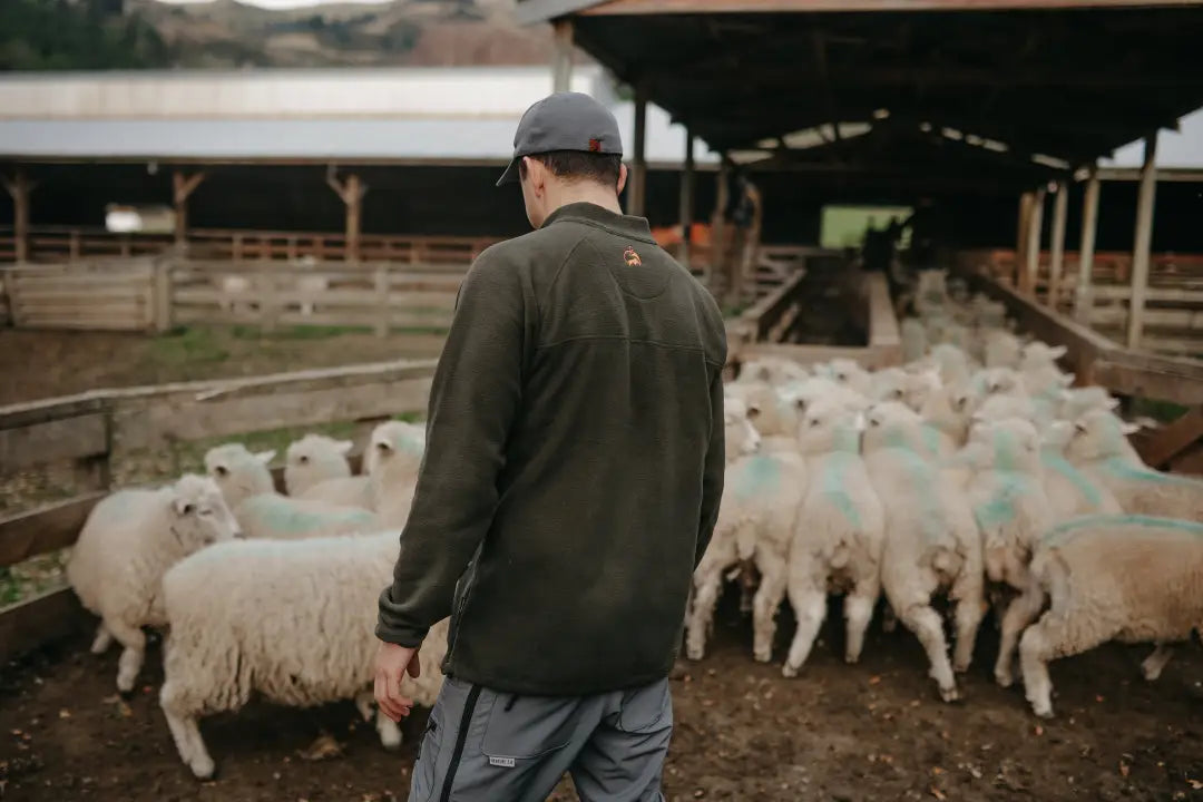 Man overseeing sheep wearing Bushbuck Vertex Fleece Half Zip for outdoor warmth