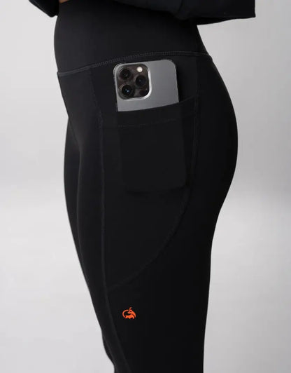 Bushbuck Womens Ascent Leggings: black with orange flame design and phone pocket for hunting outdoors