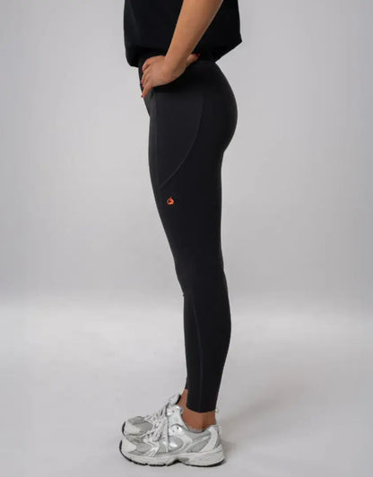 Bushbuck Womens Ascent Leggings: black with orange accents, silver sneakers for outdoors hunting