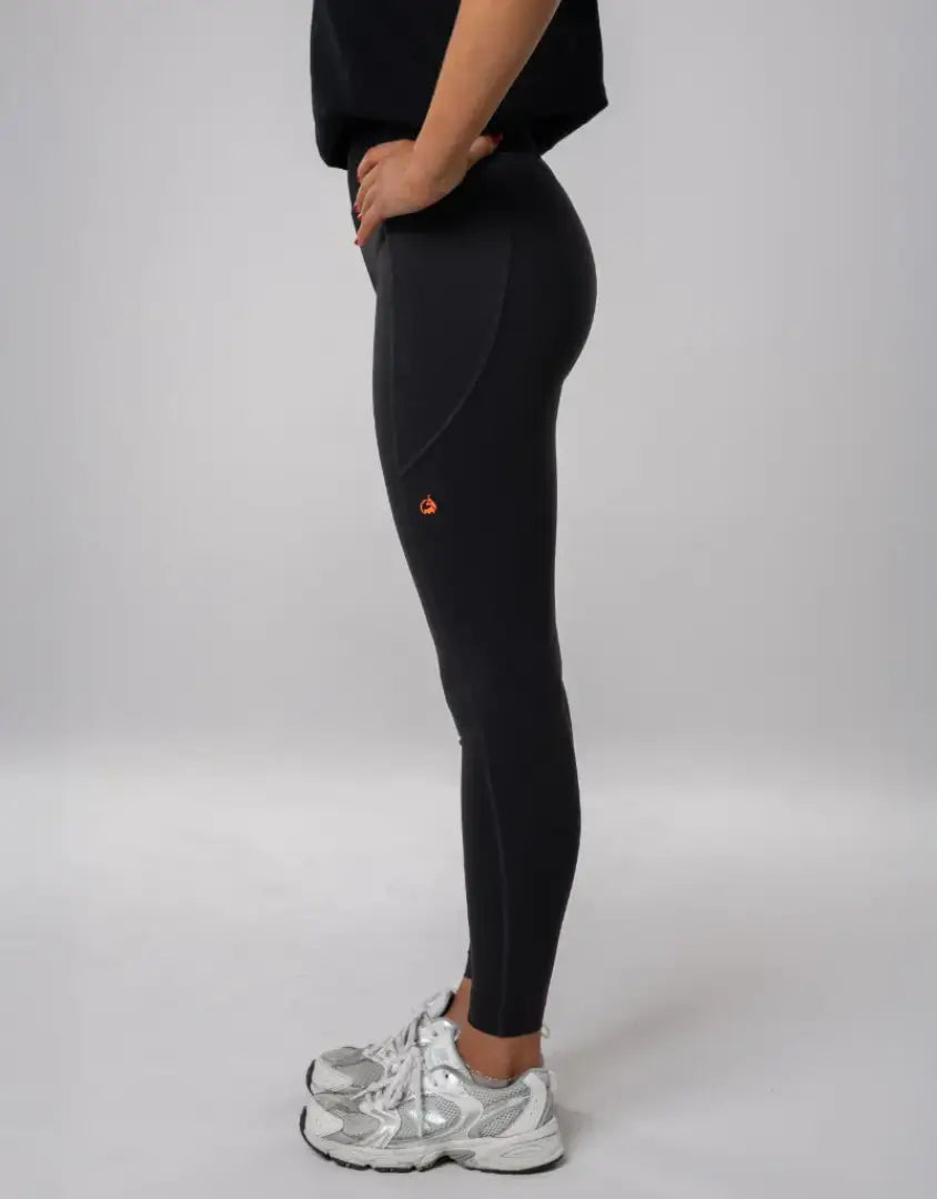 Bushbuck Womens Ascent Leggings: black with orange accents, silver sneakers for outdoors hunting