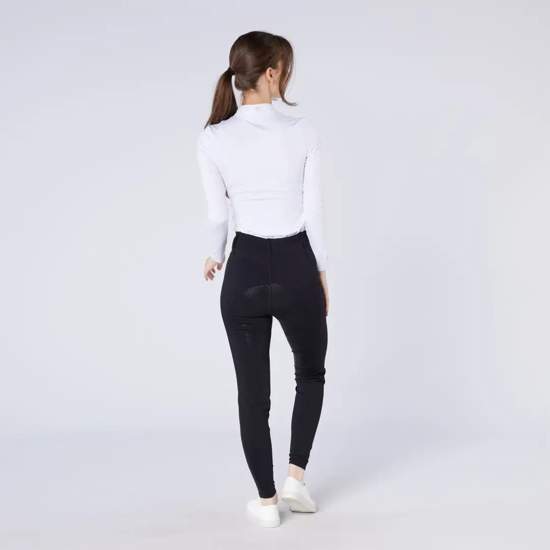 Woman in white top and black season tights for country clothing and hunting looks