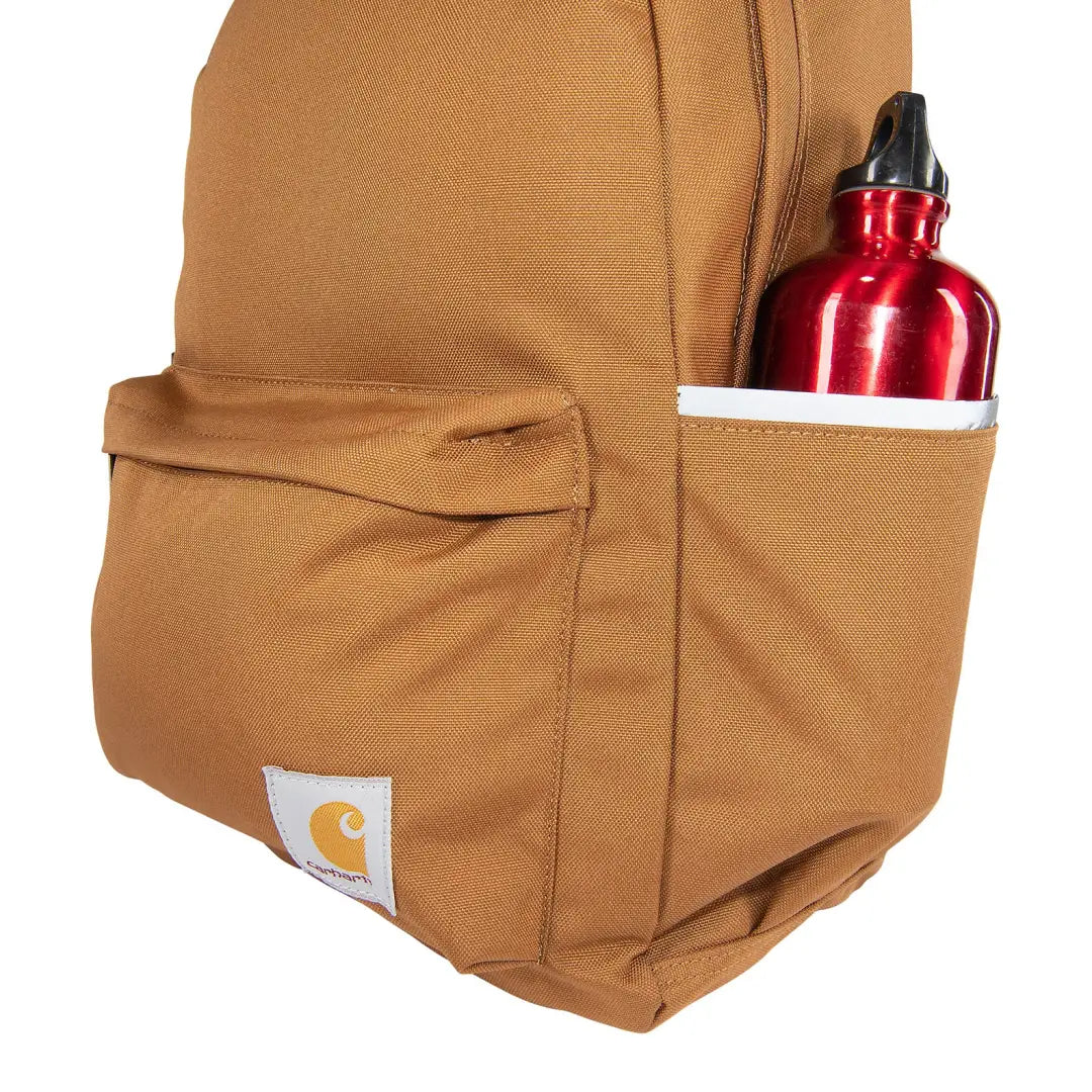Brown Carhartt 21L Classic Laptop Backpack with red water bottle for country clothing and outdoors adventures