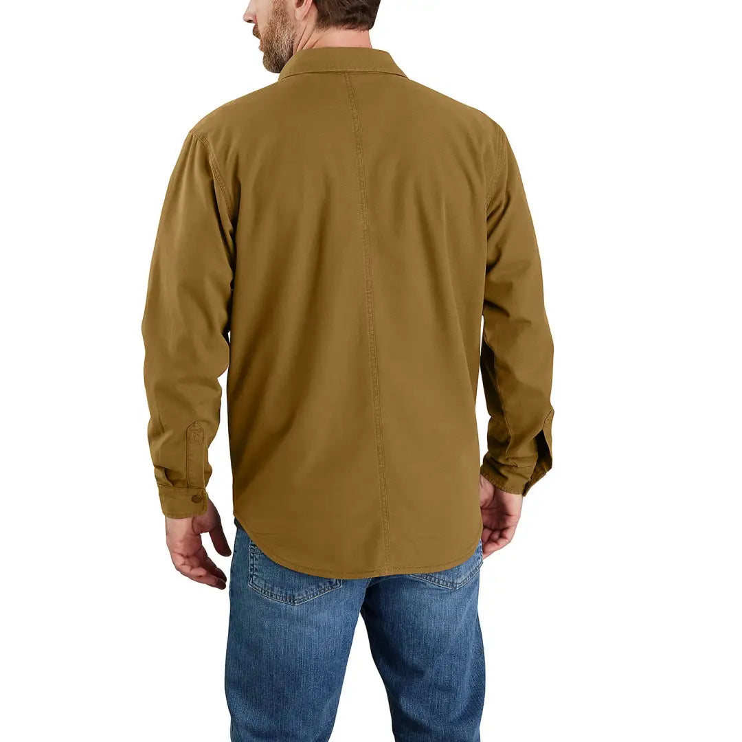 Man wearing Carhartt Canvas Fleece lined Shirt Jacket in brown with blue jeans