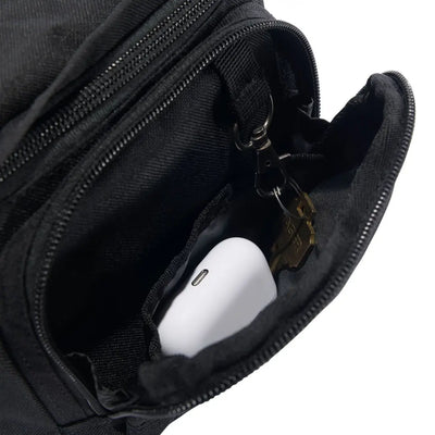 Black Carhartt Classic Waist Pack with nylon zipper pouch, earbuds and keys