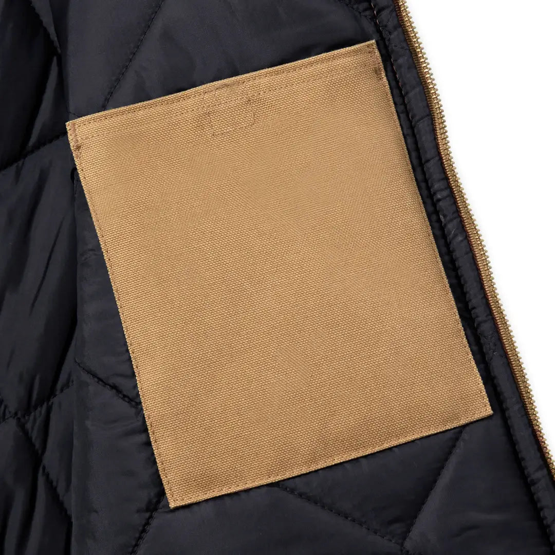 Black quilted relaxed fit Carhartt vest with rib collar and tan patch pocket