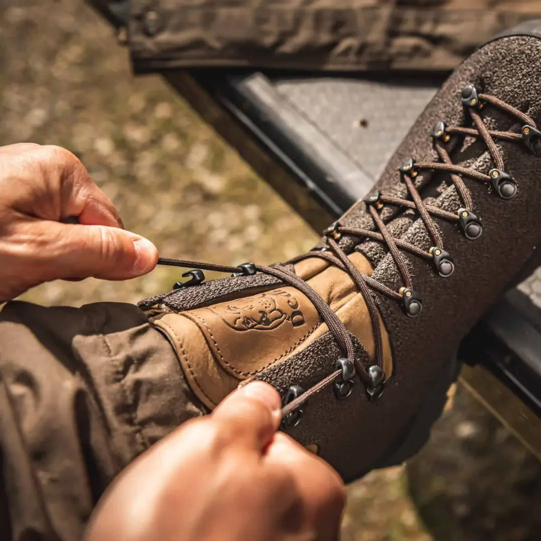 Person lacing Dedito Dodi Waterproof Boots for hunting in tough ground conditions