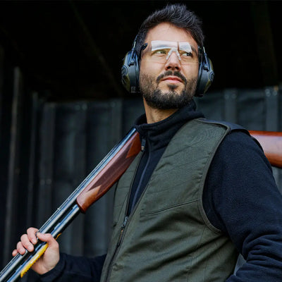 Man in safety gear with shotgun wearing the Atlas Shooting Waistcoat for optimal performance