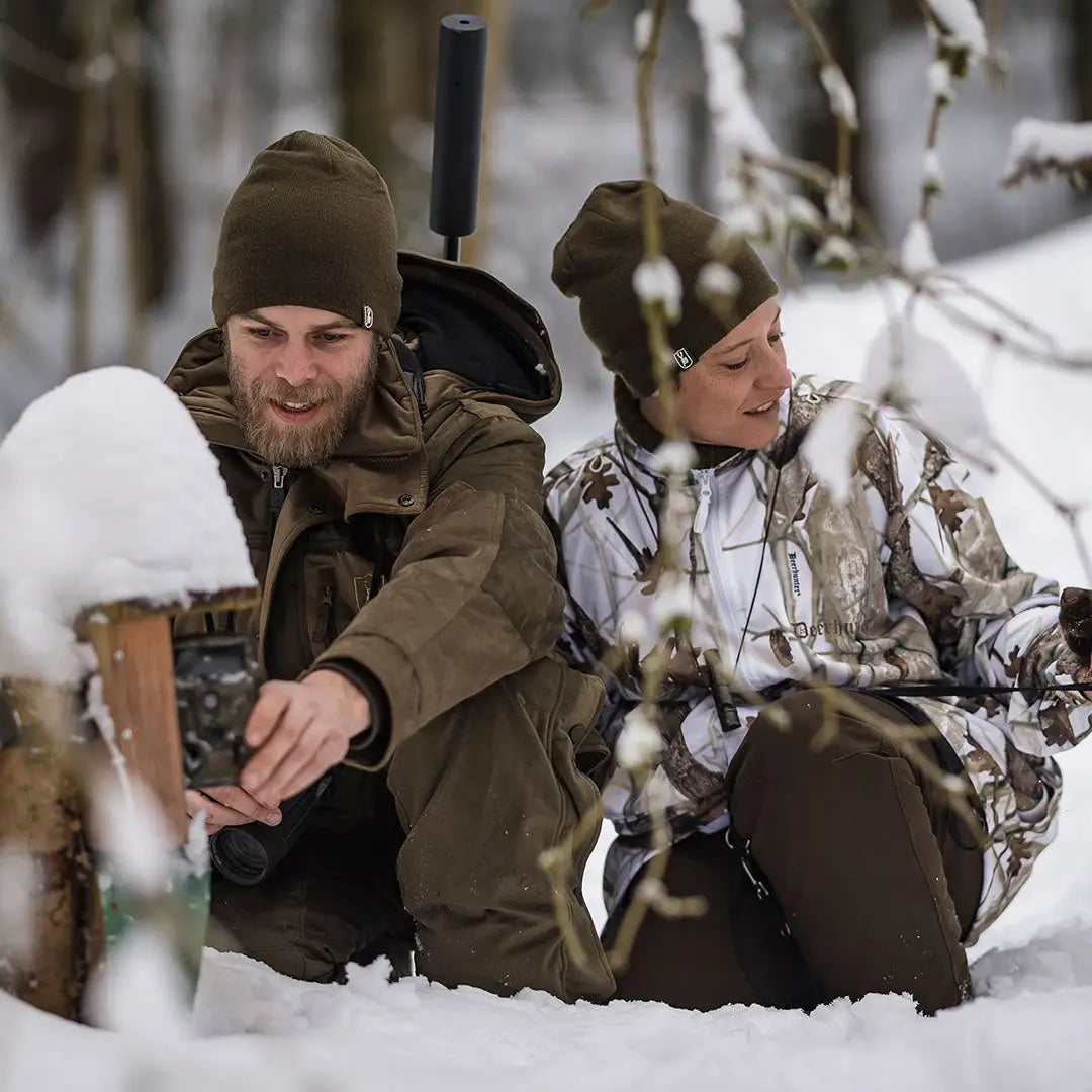 Two people wearing winter clothing and a Cumberland Knitted Beanie for cozy style