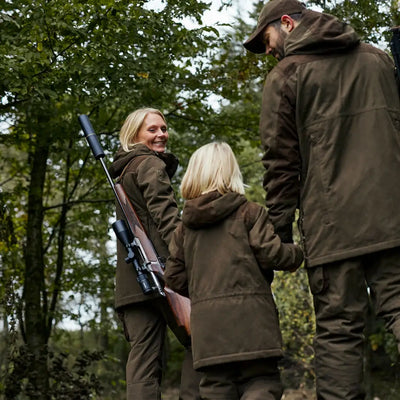 Rifle held by a person wearing the stylish Lady Eagle Jacket for hunting