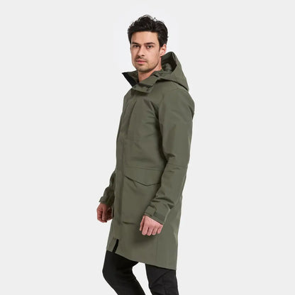 Man wearing Didriksons Andreas Parka 2, a long hooded olive green winter coat for outdoors or country clothing hunting trips