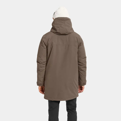 Person in Didriksons Drew Parka with brown hooded parka and white beanie for chilly days