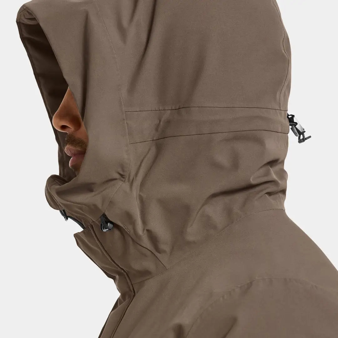 Person in brown Drew Parka waterproof jacket perfect for chilly days country clothing