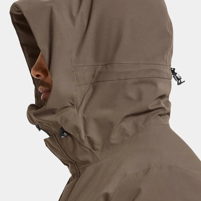 Person in brown Drew Parka waterproof jacket perfect for chilly days country clothing