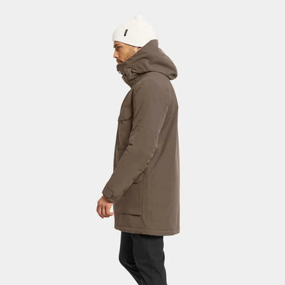 Men’s brown Drew Parka with black pants and white beanie perfect for chilly days in country clothing