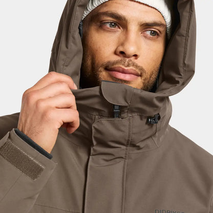 Man in Didriksons Drew Parka wearing waterproof insulated jacket for chilly days country clothing