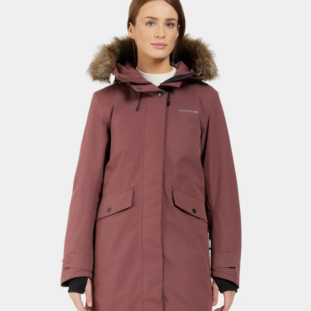 Long dark rose-colored Didriksons Erika Womens Parka with fur-trimmed hood, a classic Didriksons parka