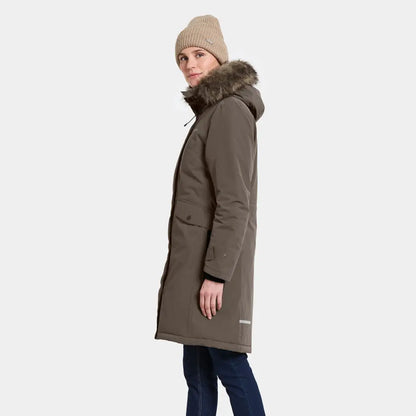 Woman wearing long olive green classic Didriksons parka with fur-lined hood
