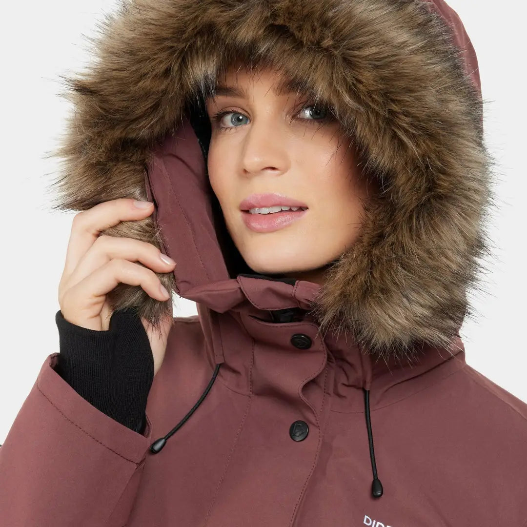 Woman in plum-colored Didriksons Erika classic didriksons parka with faux fur hood