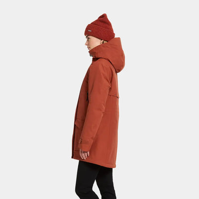 Rust-colored Didriksons Frida Womens Parka with hood and matching knit beanie, perfect sporty mid-length parka