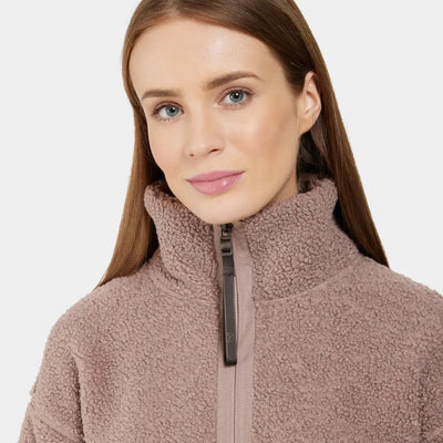 Woman in pink sherpa fleece jacket from Didriksons Mella 3 for winter snow and country hunting