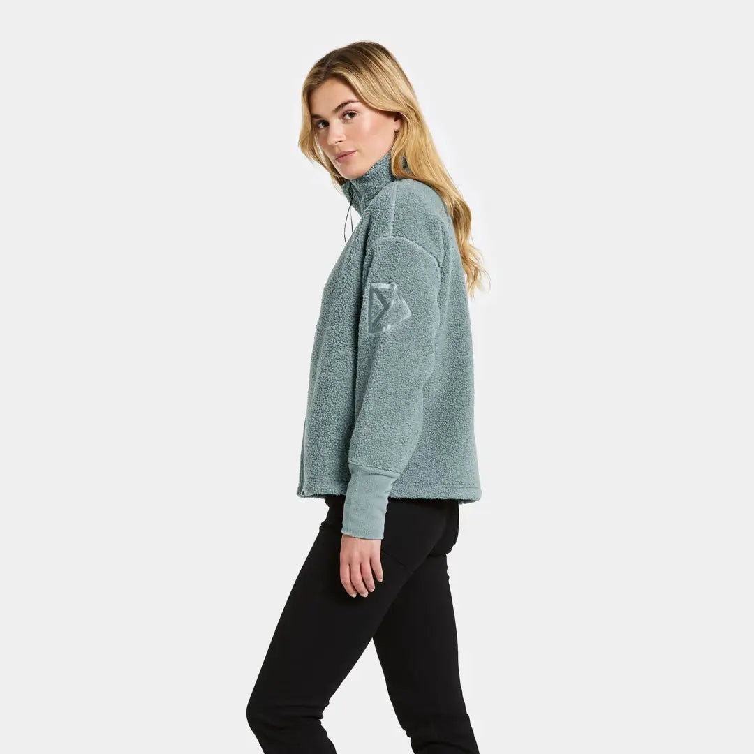 Woman in light blue fleece sweatshirt and black pants for country clothing and outdoors