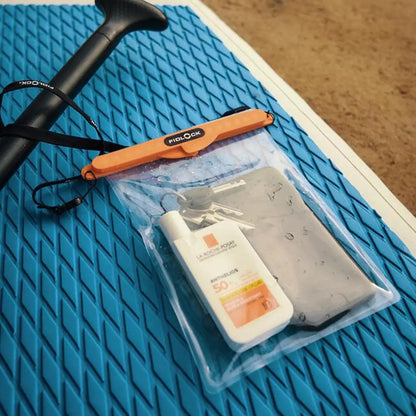 Fidlock Maxi Dry Bag with sunscreen, keys, and phone inside a waterproof pouch