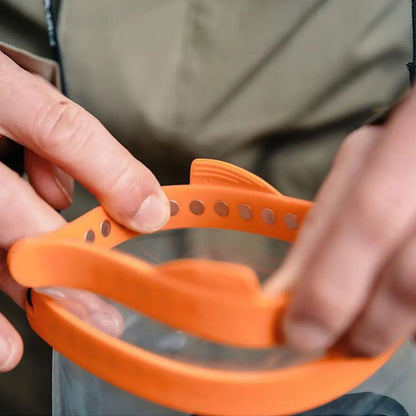 Orange fish-shaped magnetic bracelet in Fidlock Dry Bag for stylish storage