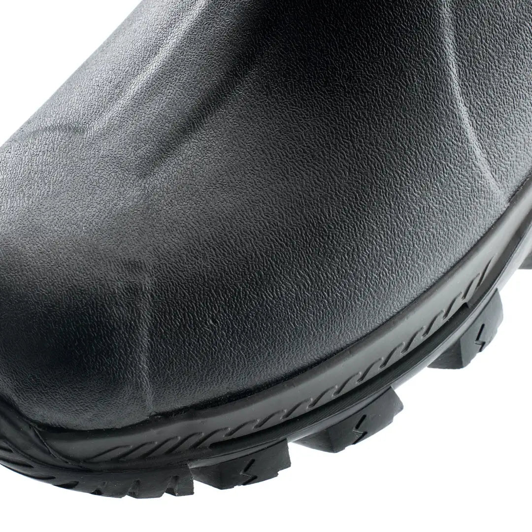 Close-up of Grubs Bearline waterproof hunting boot with thick treads and textured black finish