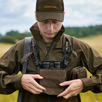 Hunter using Harkila Bino Harness for wildlife spotting in country clothing