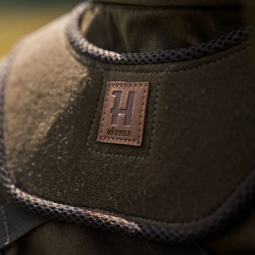 Olive green Harkila Bino Harness with brown logo, perfect for country clothing and hunting