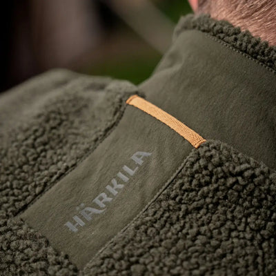 Green fleece jacket with logo for Härkila Fjell Polar Waistcoat, perfect for outdoor adventures