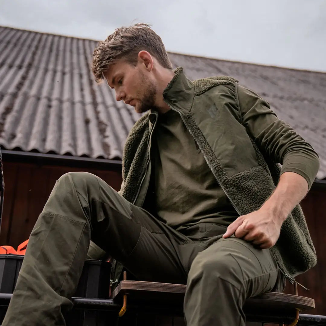 Olive green Härkila Fjell Polar Waistcoat and Pants outfit for outdoor adventures