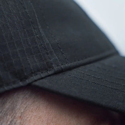 Black fabric härkila instinct cap showing the stylish härkila instinct cap design