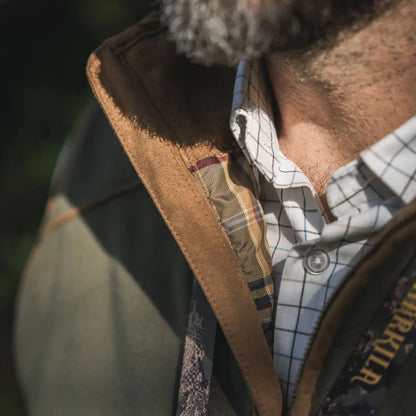 Härkila Portfield Long Sleeve Shirt showing man’s collared long sleeve shirt and jacket