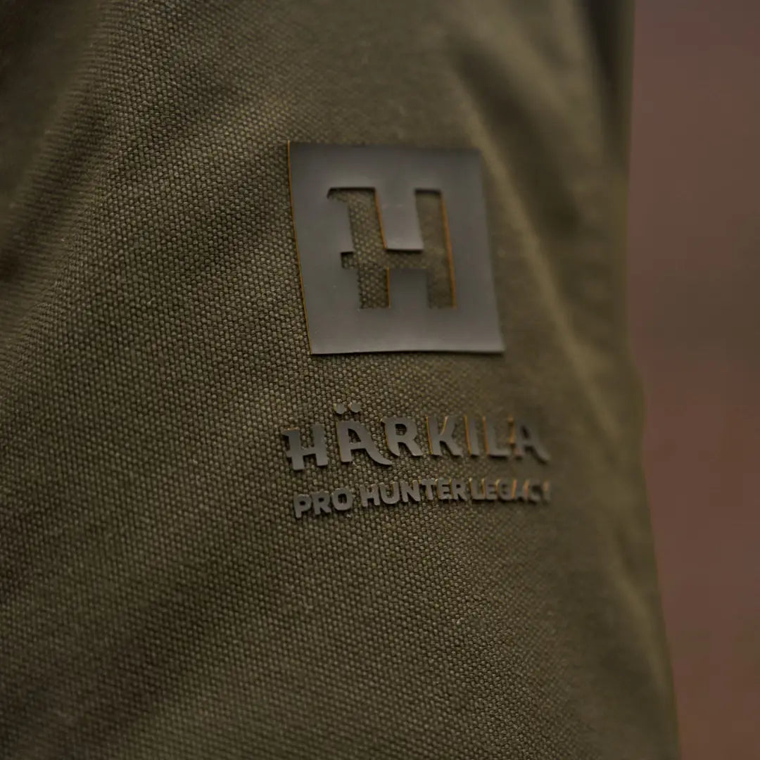 Olive green fabric with Härkila Pro Hunter GTX Legacy logo on jacket