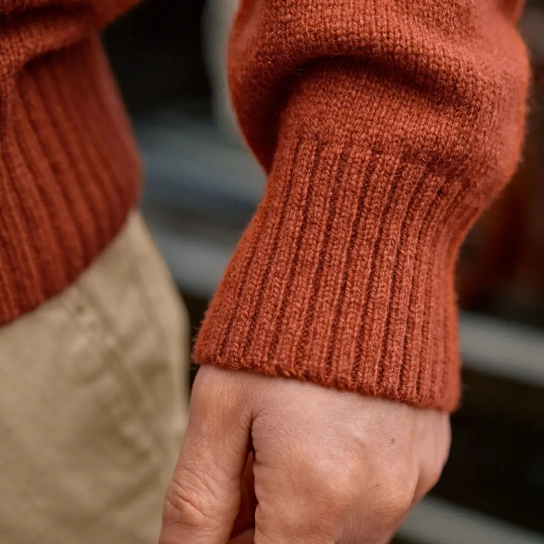 Rust-colored ribbed knit sweater cuff from Härkila Vincent Merino Half Zip Pullover