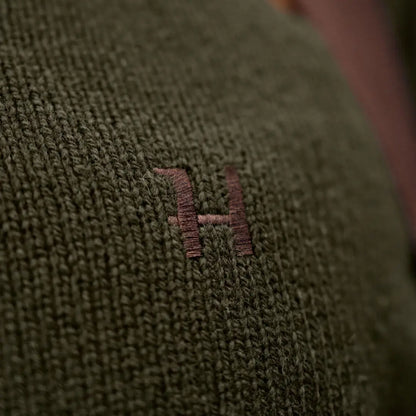 Green knitted fabric with embroidered letter on Härkila Vincent Merino Half Zip Pullover