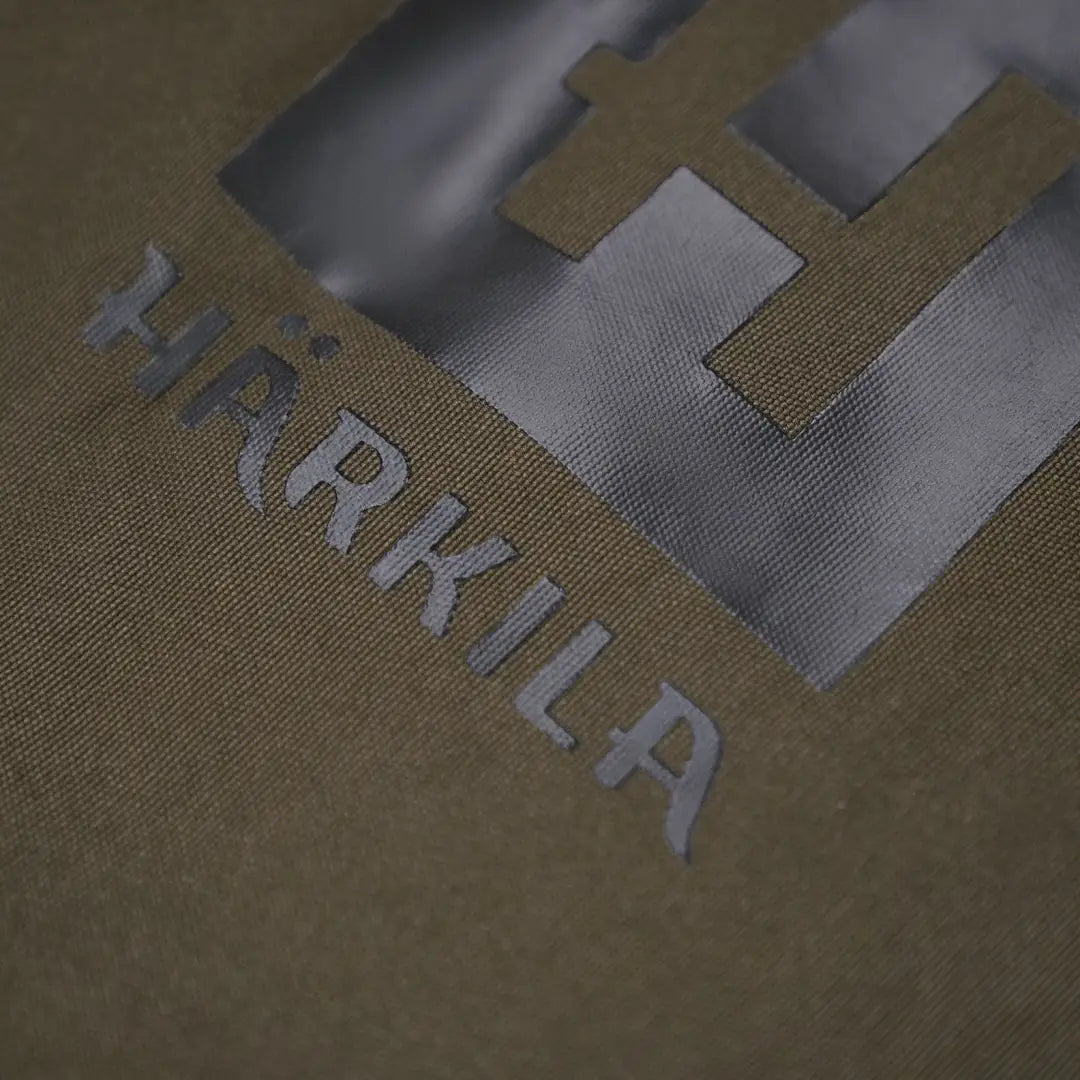 Partial view of Harkila Car Seat Cover featuring textured surface and HRKILA text