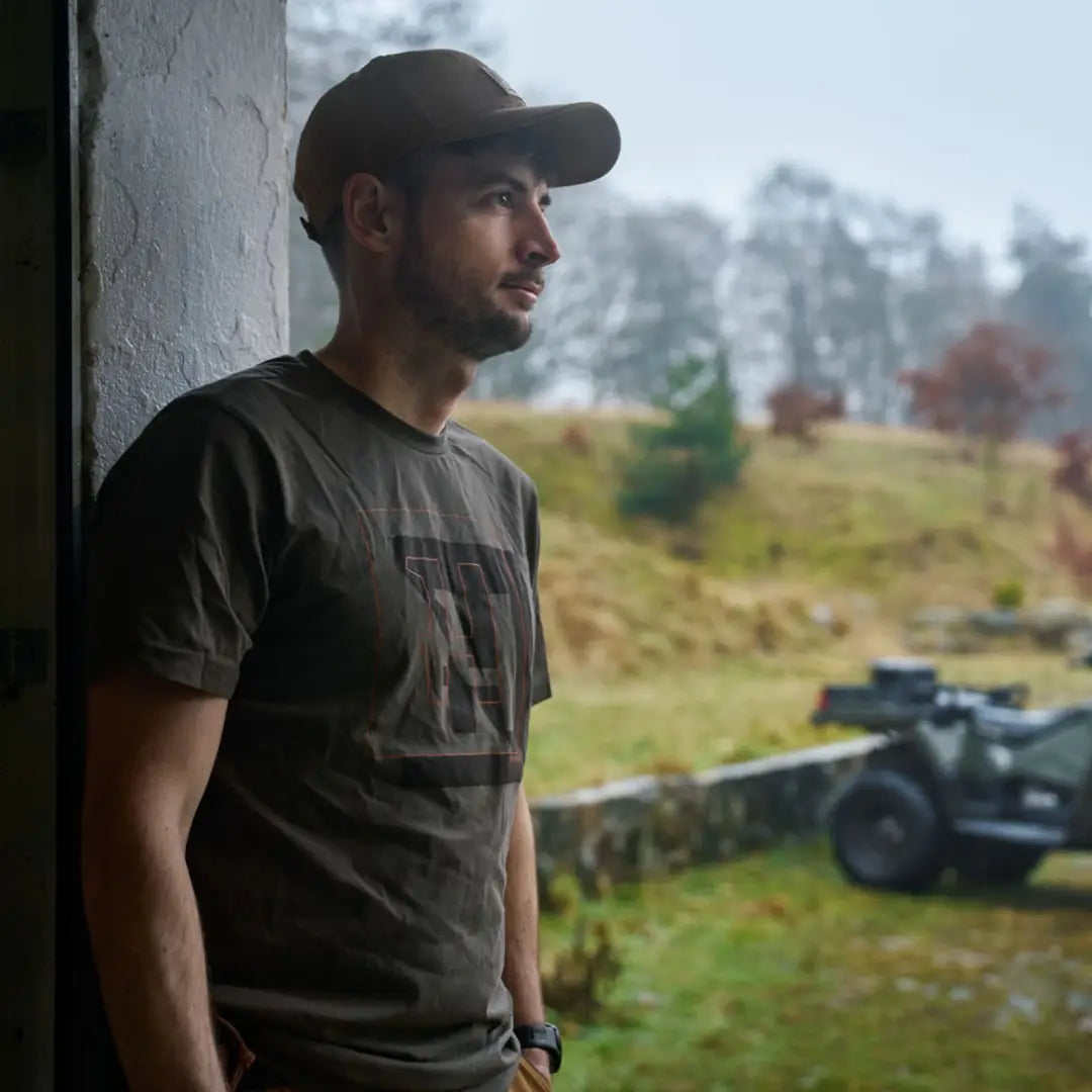 Man wearing Harkila H-logo Short Sleeve T-Shirt with cap, casual outdoors look