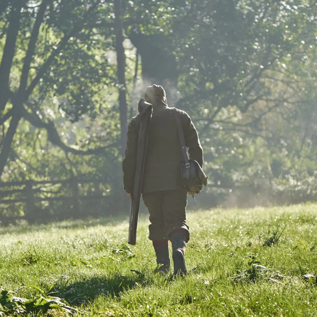 Hunter walking with rifle wearing Harkila Kenmore GTX Breeks outdoor gear